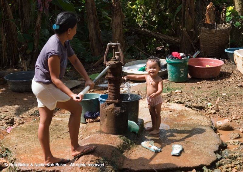 Mother and Child at the Water Pump